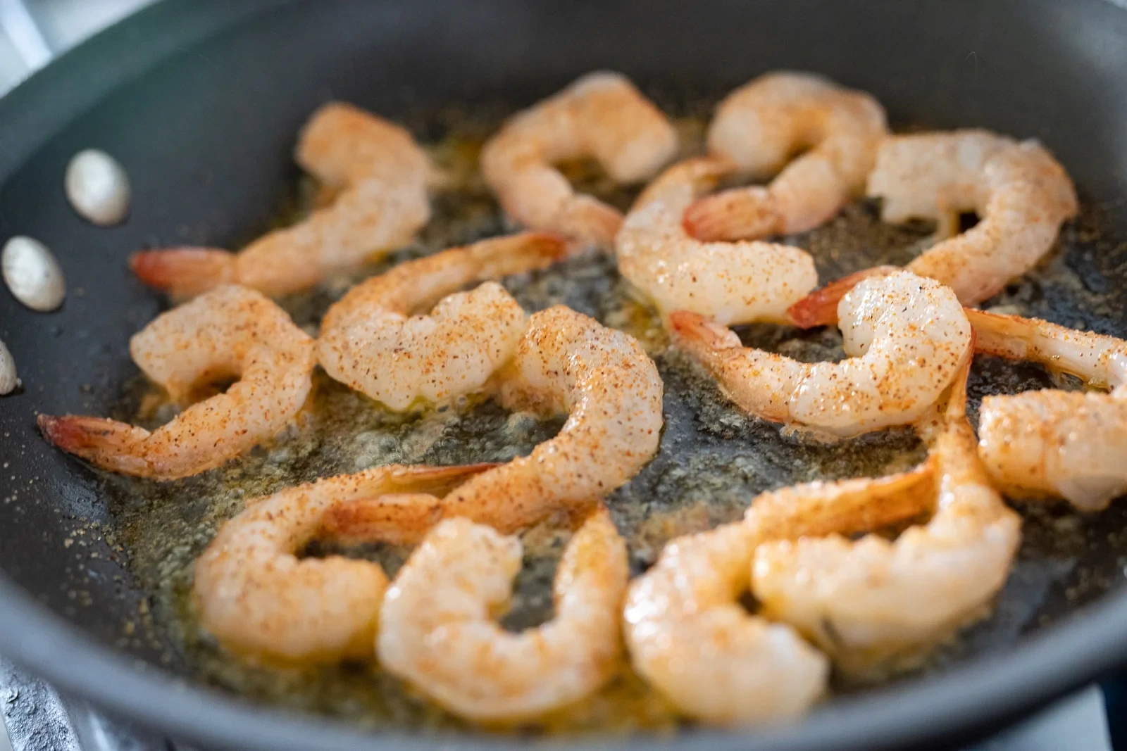 Why do prawns curl when cooking?