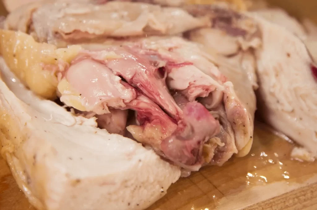 “Cooked chicken with slight pink near bone