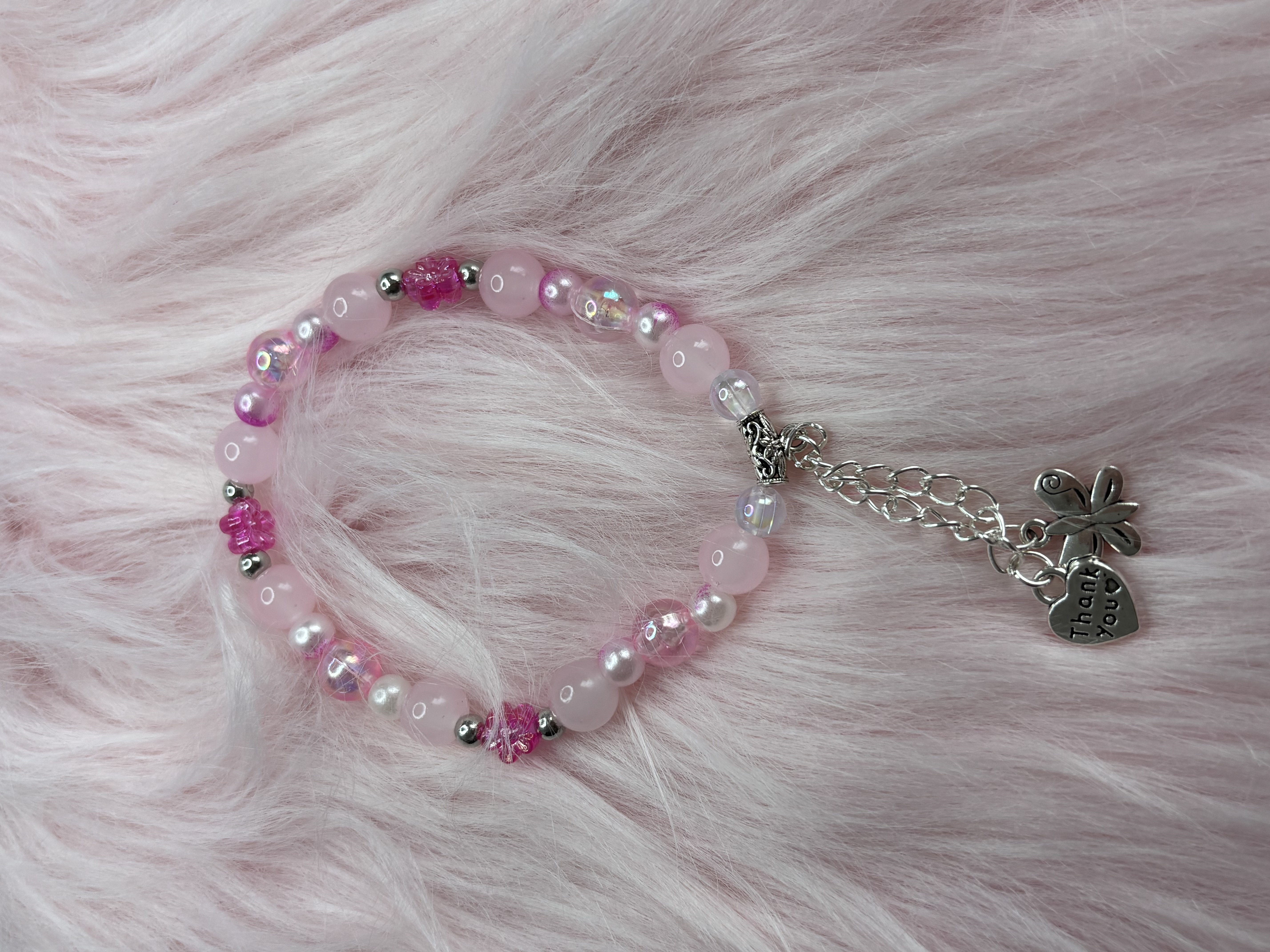 Pink beaded bracelets with charms