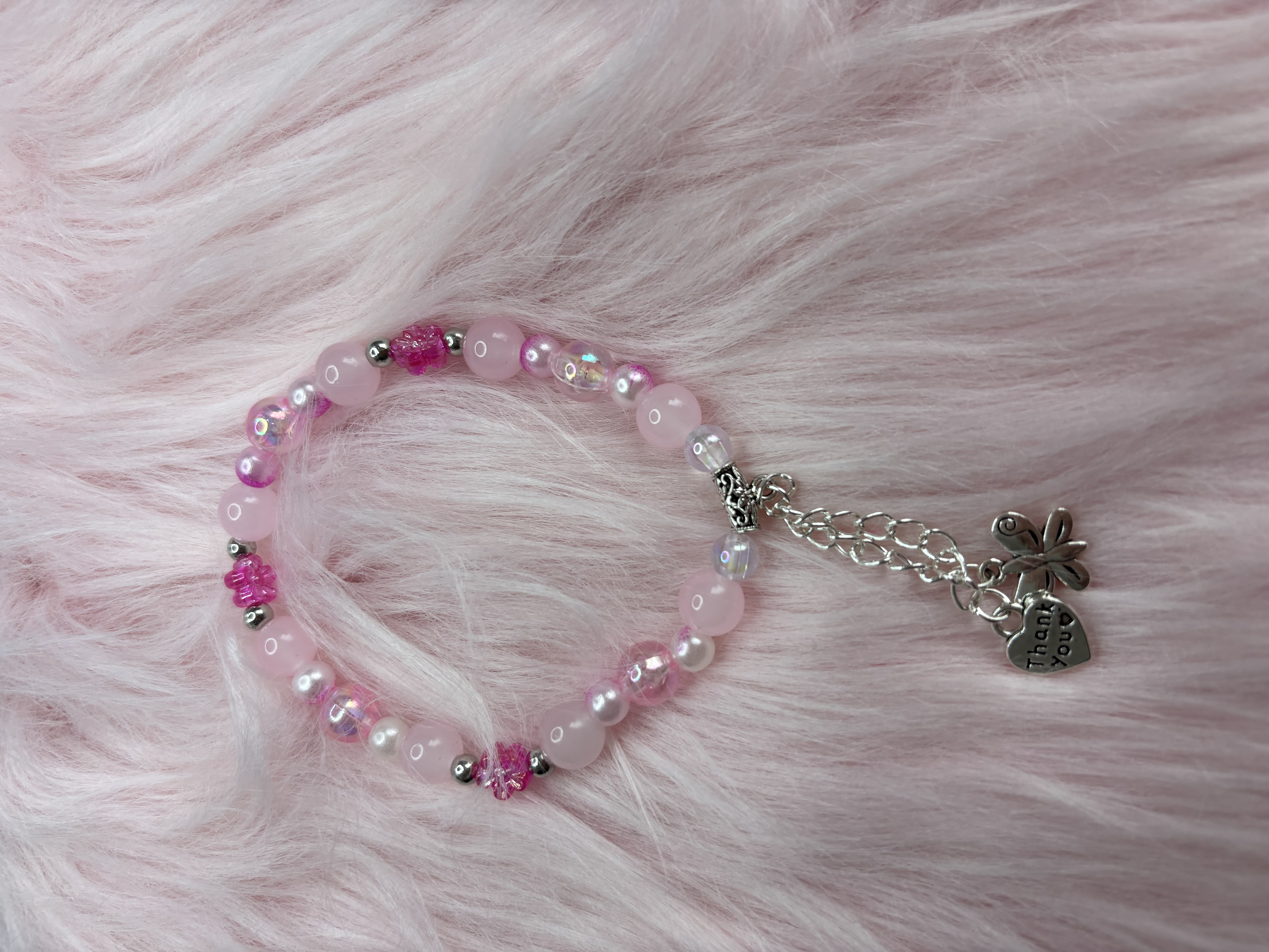 Pink beaded bracelets with charms