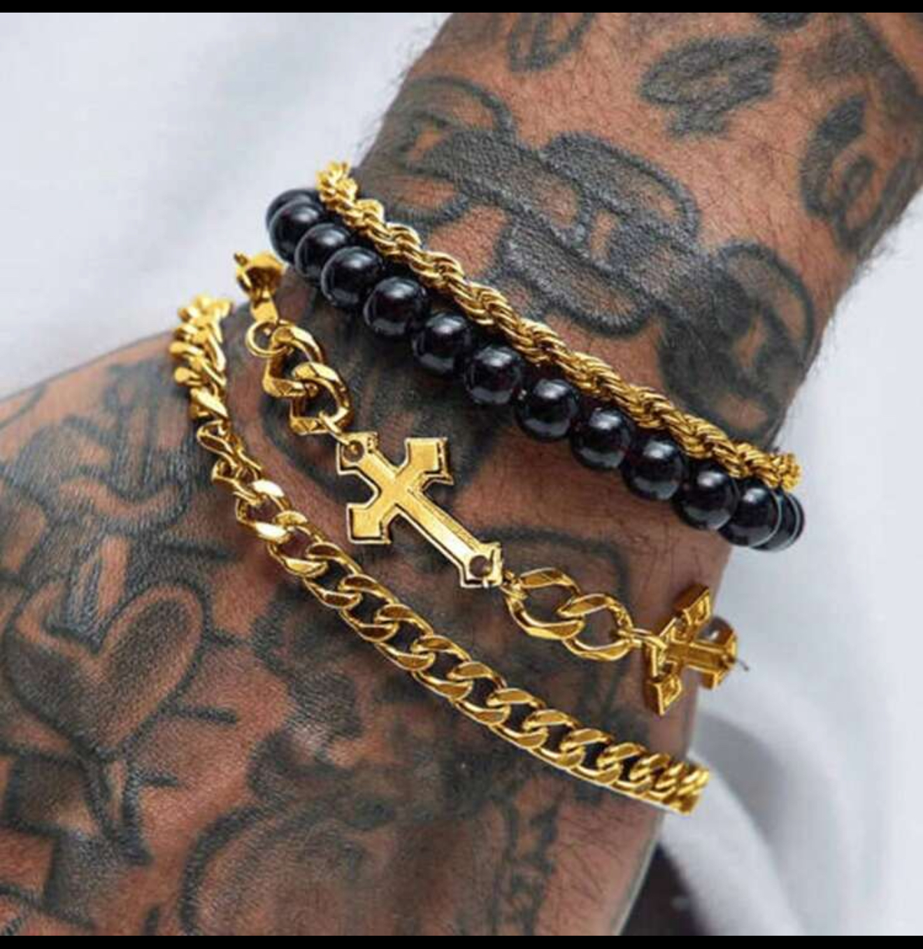Four gold & black tone bracelets for men