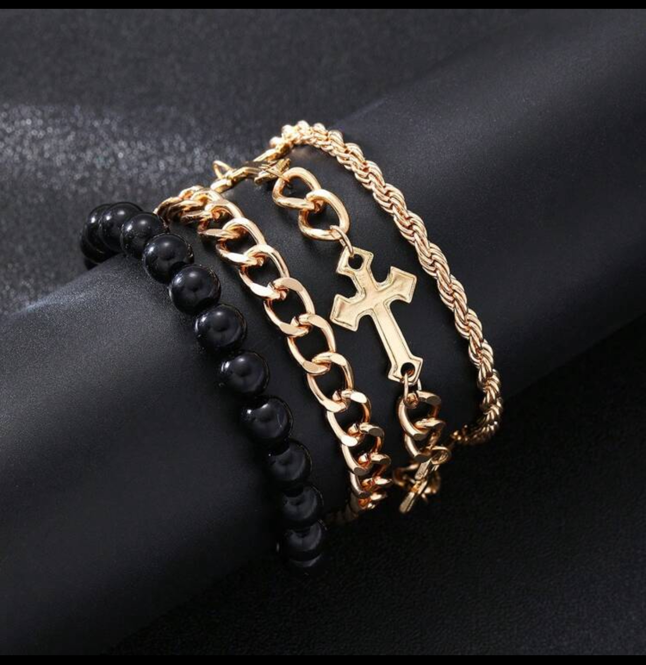 Four gold & black tone bracelets for men
