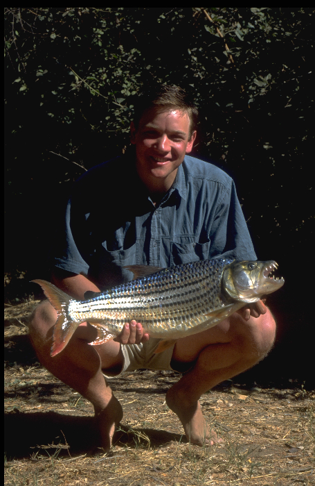 A much younger nineteen year old Ian Lewis holding a Zambezi river tiger fish