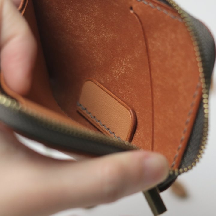 Card tab inside a tan Remi zipper wallet