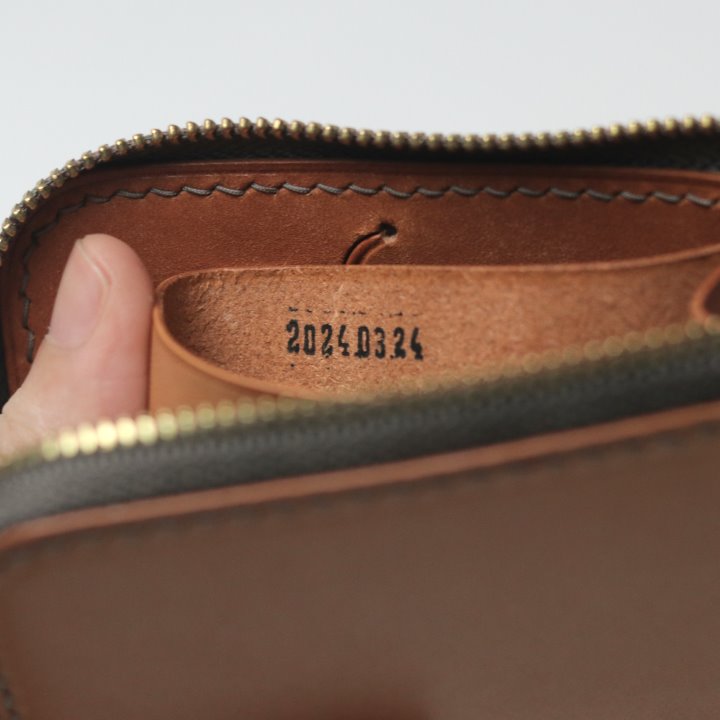 Date inside a tan Remi zipper wallet
