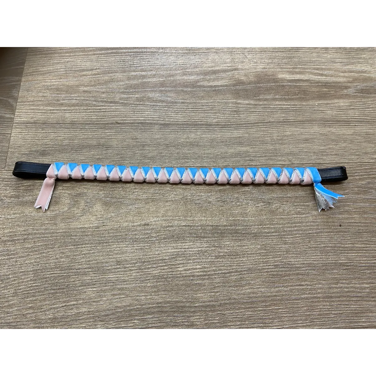 Sky blue and pale pink browband with silver underlay. Pony size. .Black leather.