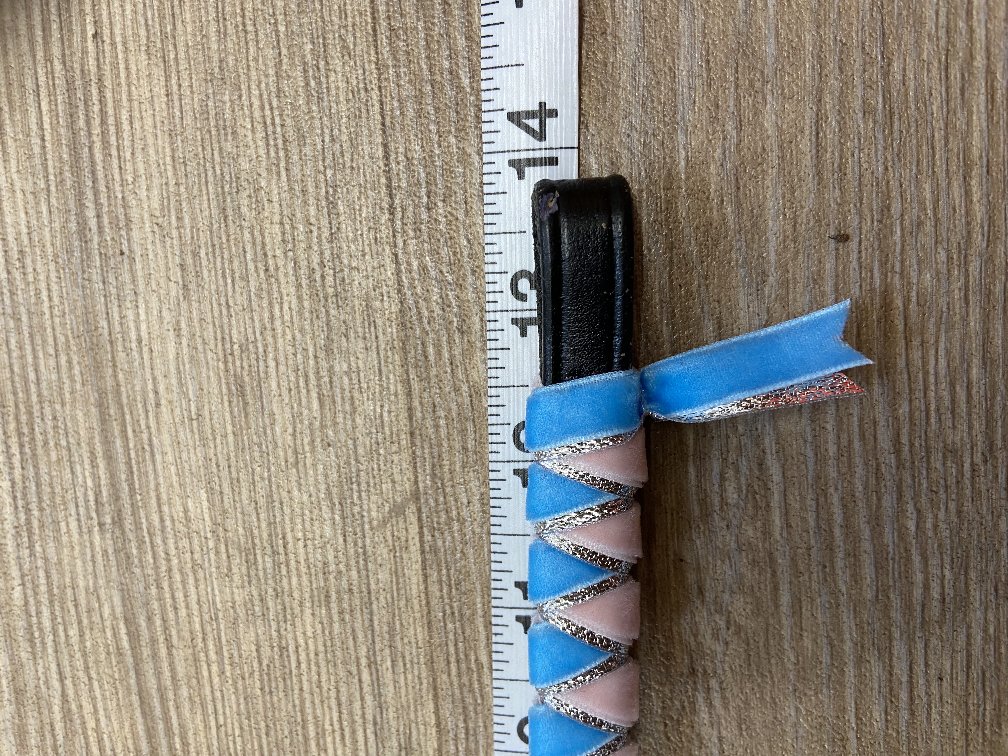 Sky blue and pale pink browband with silver underlay. Pony size. .Black leather.