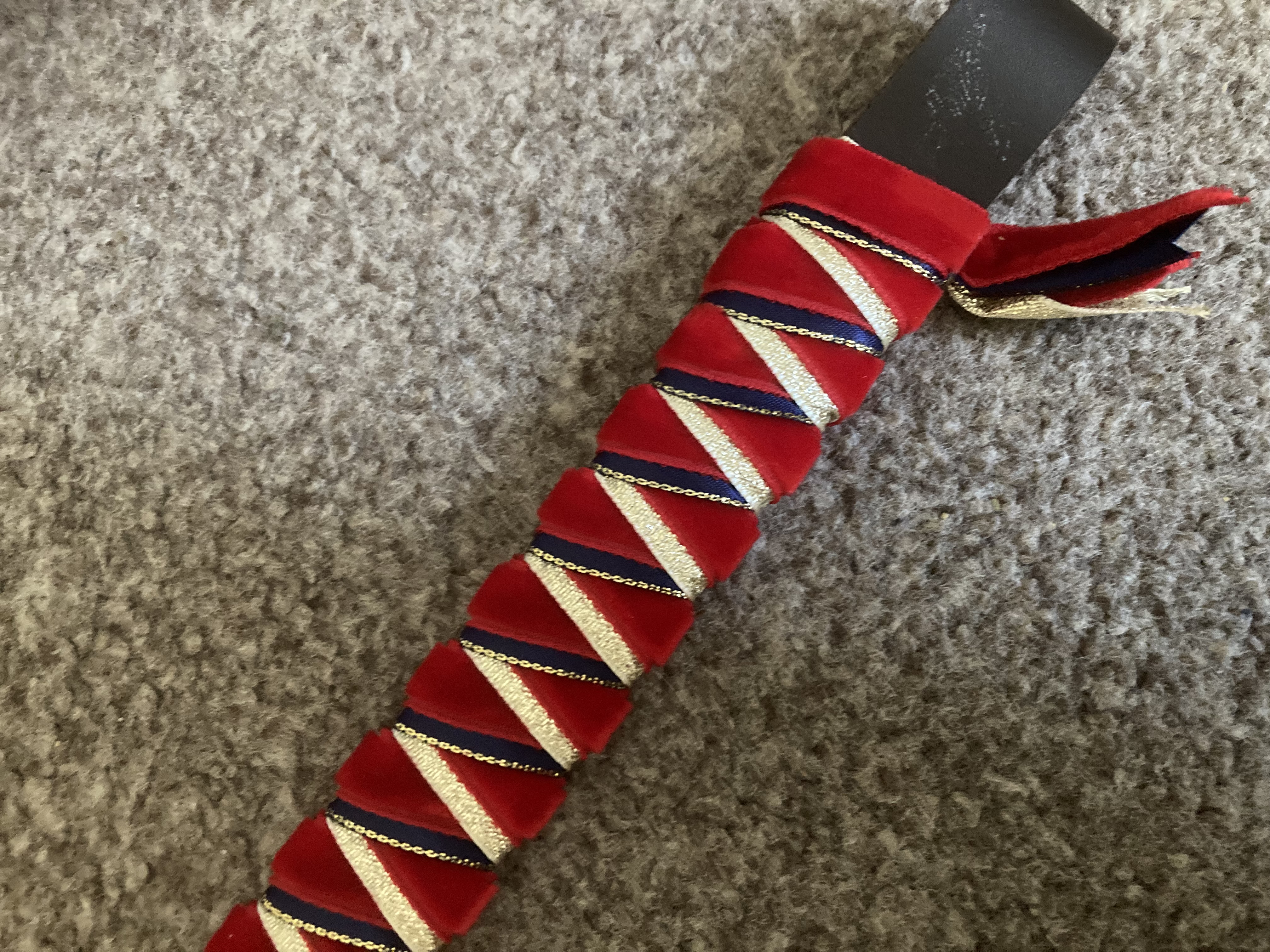 Red/Navy/Gold sharkstooth ribbon browband. 15” brown leather base.