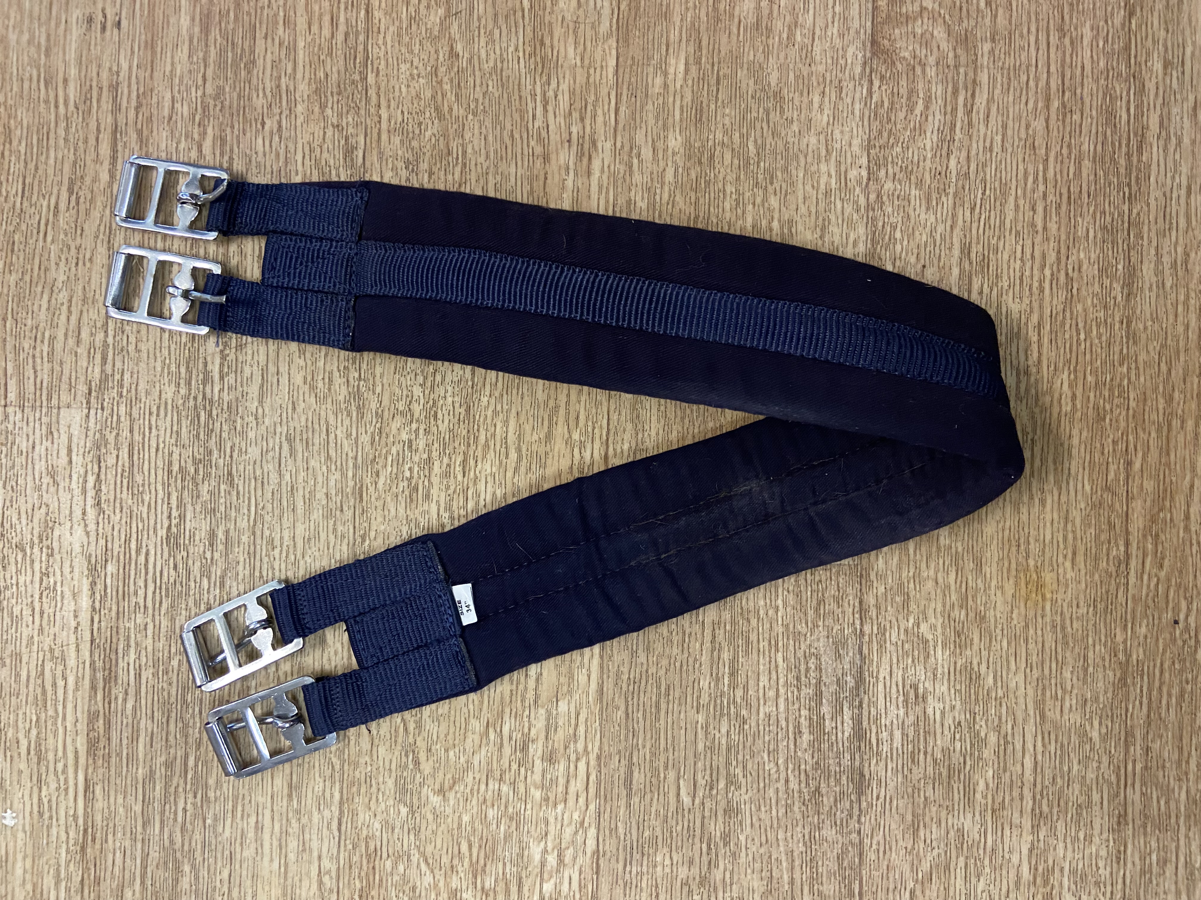Navy nylon padded girth. 34”. Preowned. Used once.