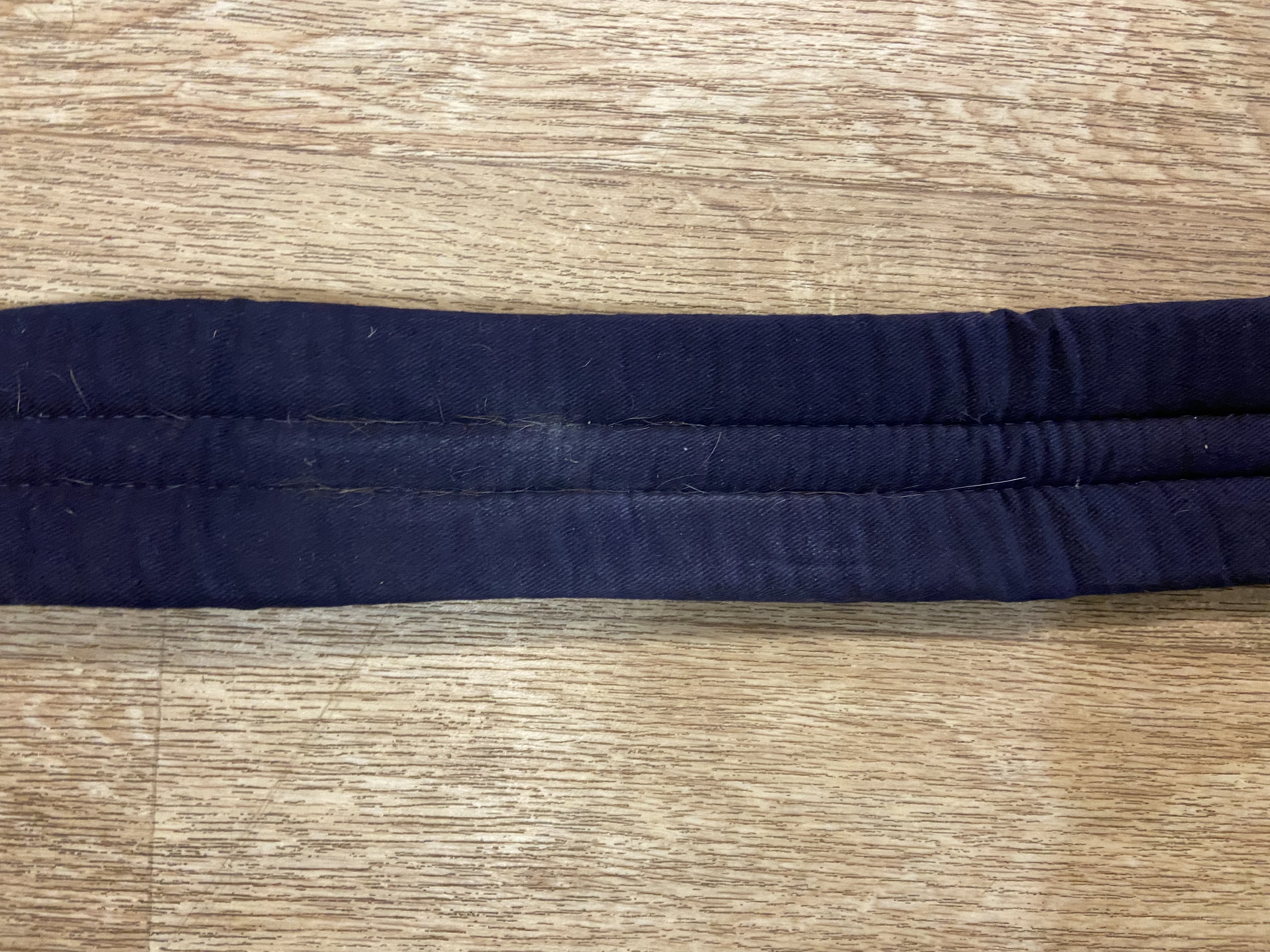 Navy nylon padded girth. 34”. Preowned. Used once.