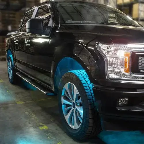 A sports car at night with vibrant blue underglow from the Custom Accessories LED strip