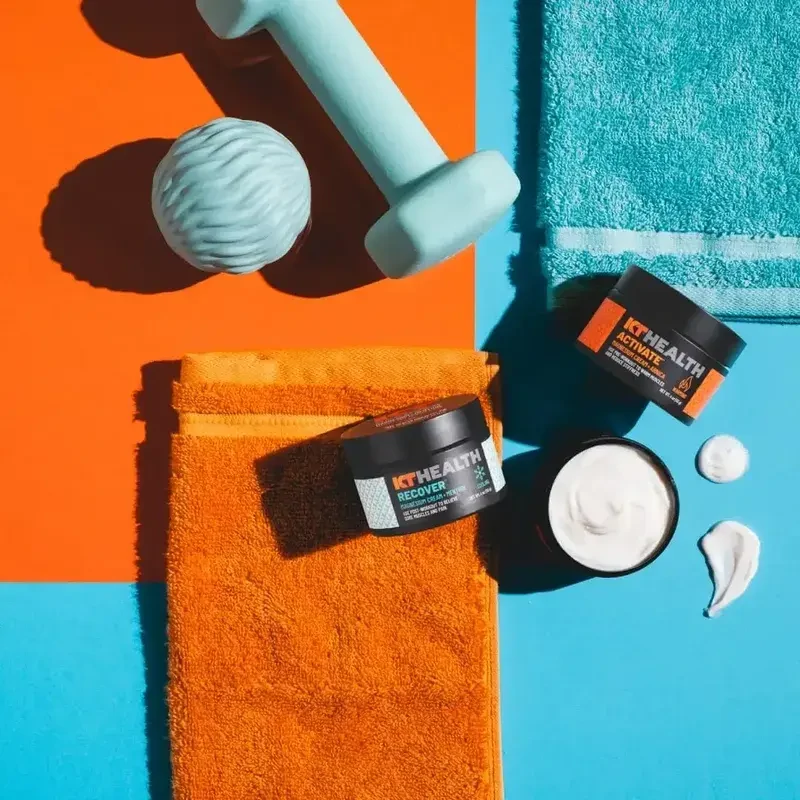 A person applying the KT Health Magnesium Cream to their calf muscle to relieve soreness.