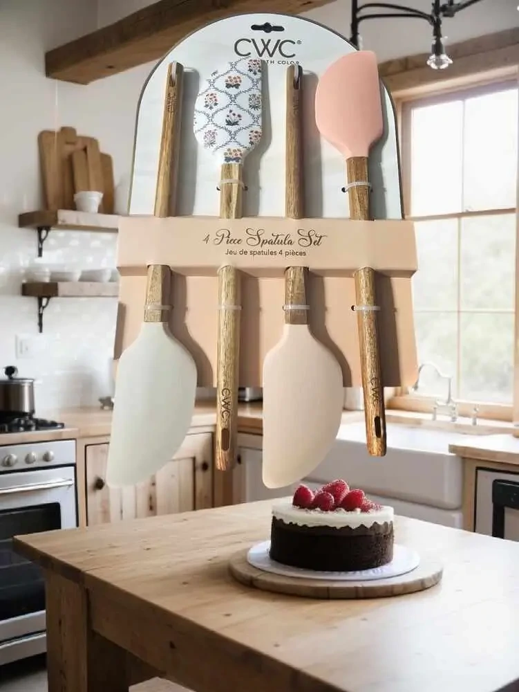 Cook With Color 4-piece spatula set displayed in a modern farmhouse kitchen with a chocolate cake, highlighting their stylish design.