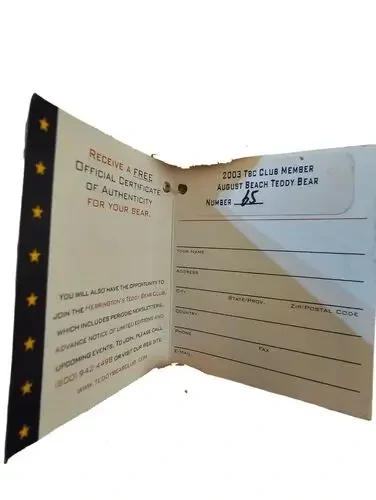 A close-up of the original, intact tag of authenticity showing it is the 2003 TBC Club Member bear, Number 65.