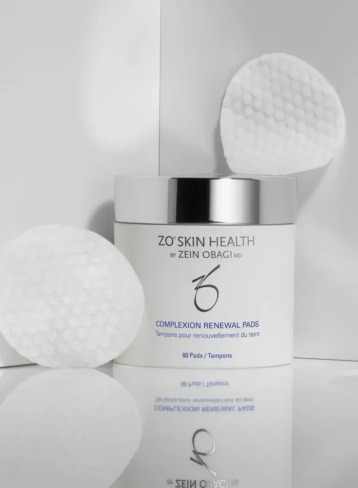 A single ZO Complexion Renewal Pad shown up close, highlighting its textured surface for effective exfoliation.