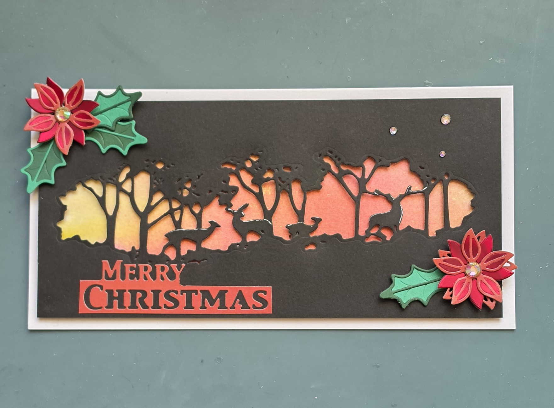 Poinsettias and Pinewood Silhouettes – Handmade Christmas Card by Angie Davis