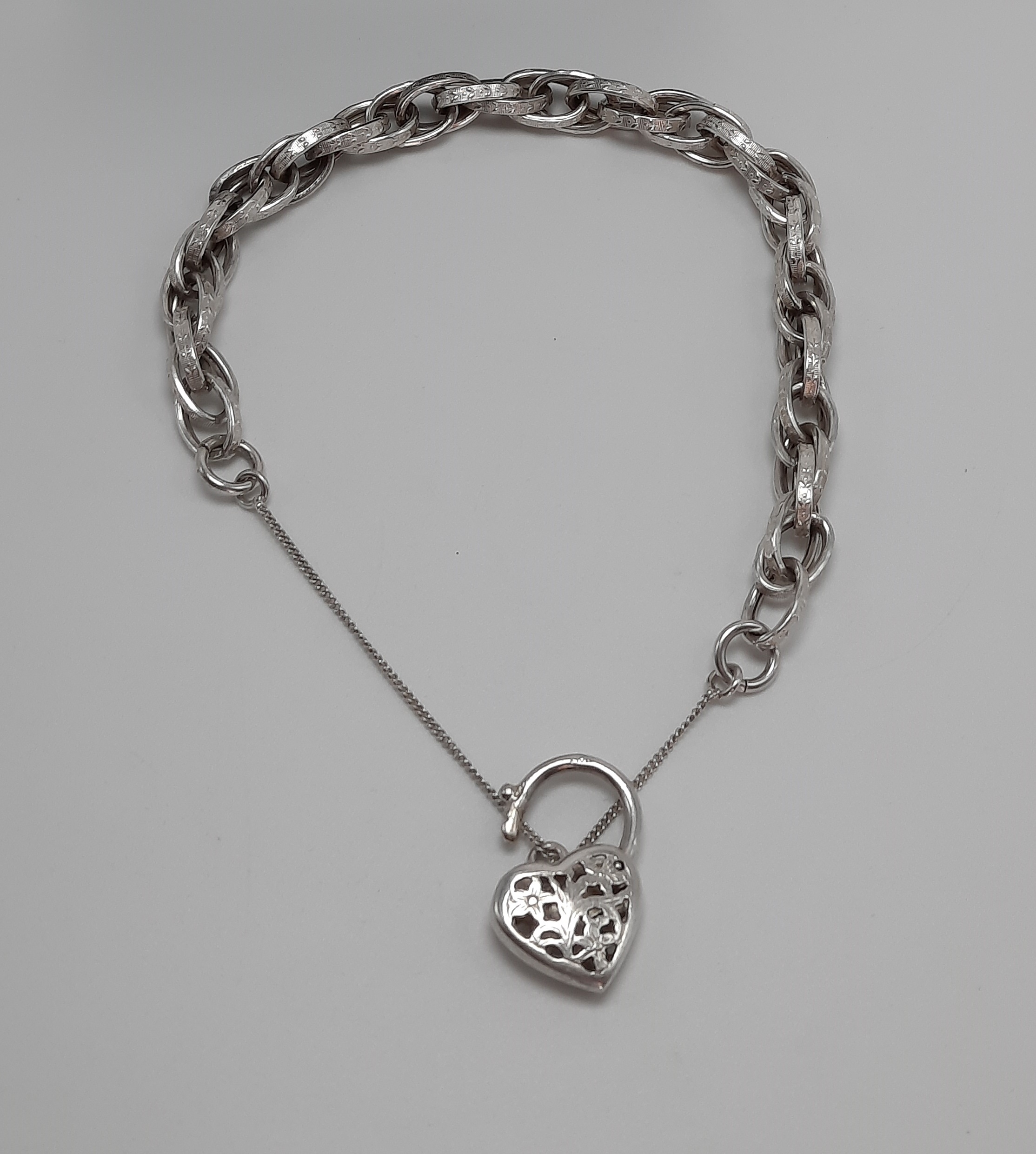 Sterling Silver Fancy Link Bracelet with Floral Pierced Padlock
