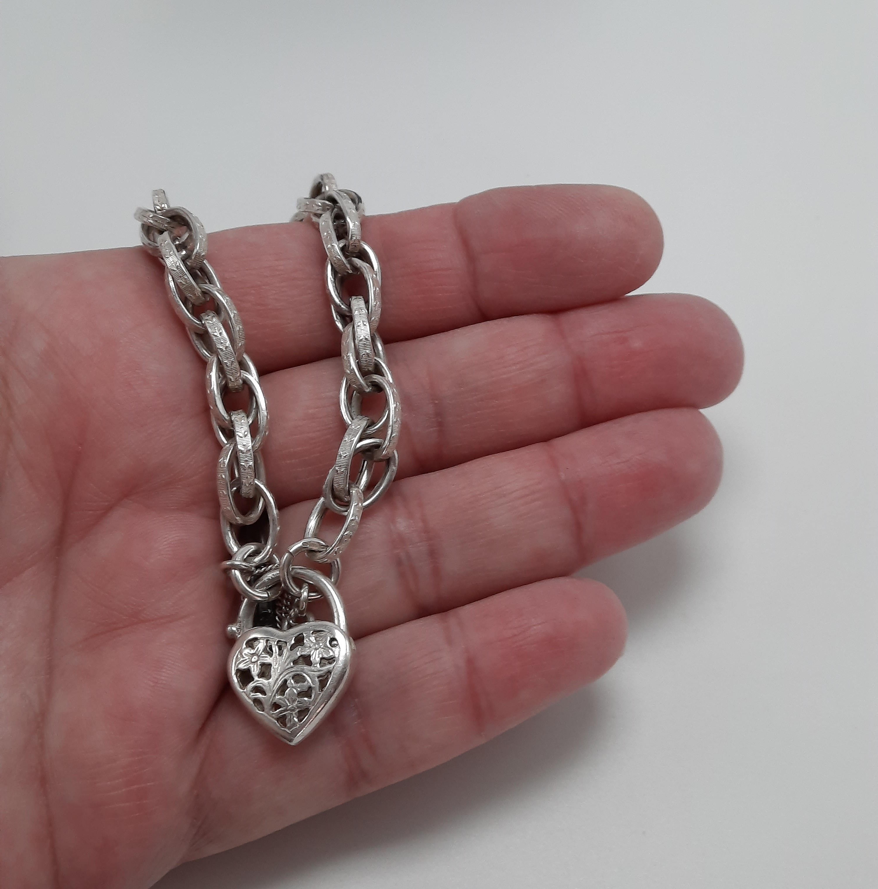 Sterling Silver Fancy Link Bracelet with Floral Pierced Padlock