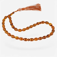Pressed amber rosary cognac color..