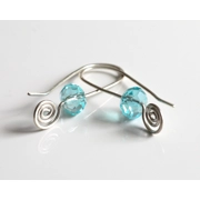 These are whimsical handmade long silver wire threader earrings with a swirl design that is accented by vibrant blue turquoise crystals for an eye-catching flair. These statement earrings easily thread through the earlobe and are crafted with Argentium Sterling Silver wire which is highly tarnish resistant and more pure than traditional sterling silver (935 vs 925) and made using recycled silver.

NOTE: These earrings are made with 18 gauge wire which would be suitable for slightly larger piercings.

Measurement: 1-1/2