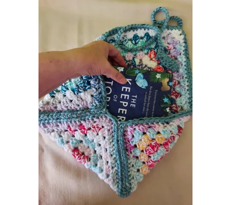 Crocheted book pouch or tablet case, wrap round fastening, multicoloured.