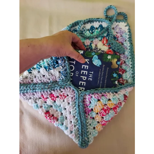 Crocheted book pouch or tablet case, wrap round fastening, multicoloured.