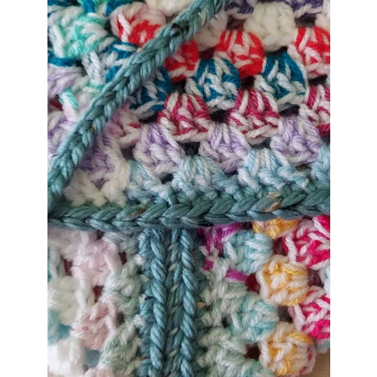 Crocheted book pouch or tablet case, wrap round fastening, multicoloured.