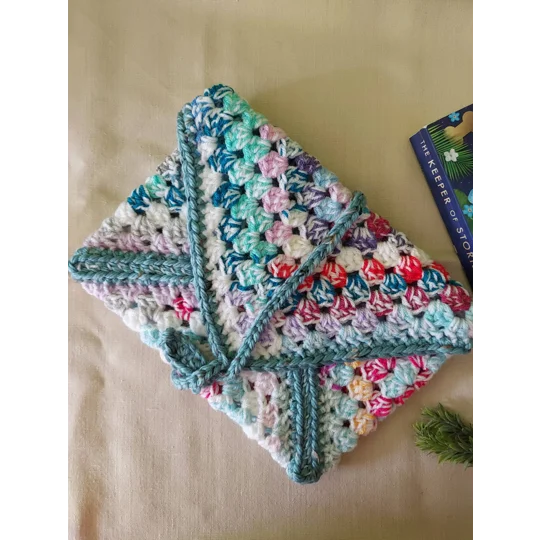 Crocheted book pouch or tablet case, wrap round fastening, multicoloured.
