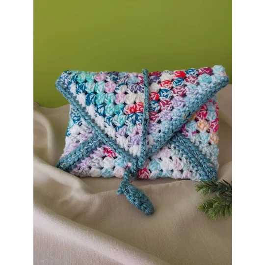 Crocheted book pouch or tablet case, wrap round fastening, multicoloured.