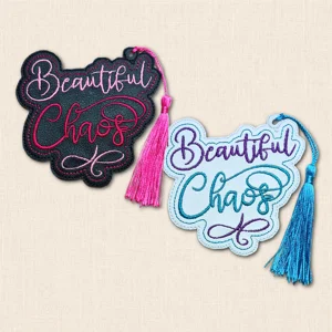 Black and white Beautiful Chaos embroidered bookmarks with contrasting colourful stitching and silky tassels.