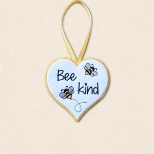 Bee Kind heart hanger made from white felt with black, grey and golden yellow embroidery, two bees and a yellow ribbon loop.