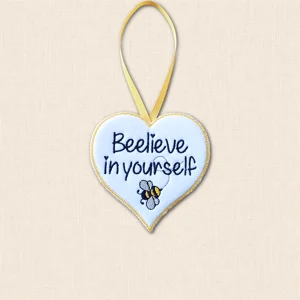 Beelieve in Yourself felt heart hanger with black embroidered wording, grey and golden yellow bee, flight trail and yellow ribbon loop.