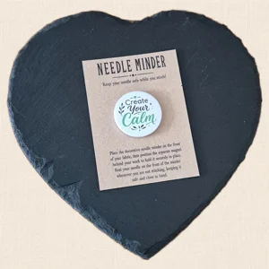 Create Your Calm magnetic needle minder on a kraft presentation card displayed on a black heart-shaped slate