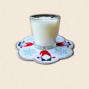 Christmas Gnome Candle Mat with glass candle jar, embroidered festive gnomes, blue snowflakes and scalloped grey edging