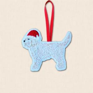 Cockapoo Christmas decoration embroidered on pale felt with detailed curly coat stitching, red Santa hat and red hanging ribbon