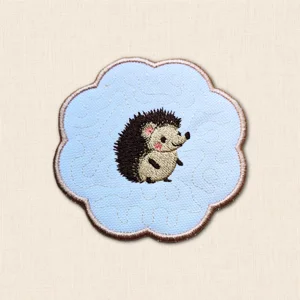 Hedgehog Candle Coaster with embroidered hedgehog, subtle stitched background and softly scalloped brown edging