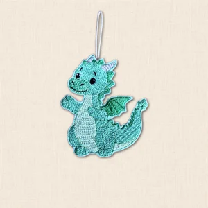 Green embroidered Knit Stitch Dragon Hanging Decoration with tiny wings, silver horns and a smiling face, finished with a hanging loop.