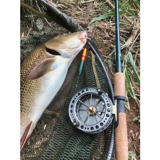 Angler’s barbel catch alongside handmade grayling-style float used for trotting the bait