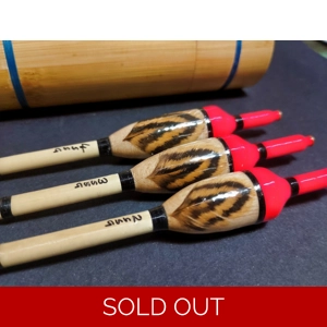 Close-up detail of feather inlay on balsa fishing float body