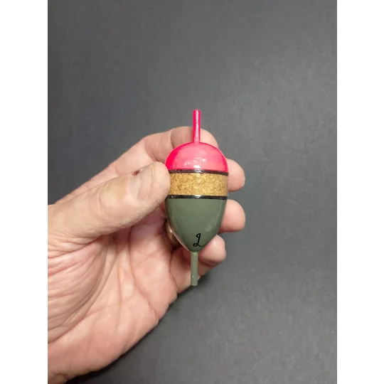 Cork inline pike float being held for scale