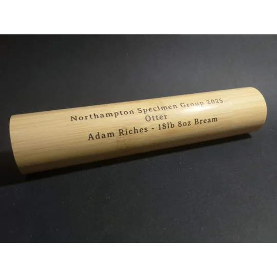 Personalised bamboo fishing float tube on black background