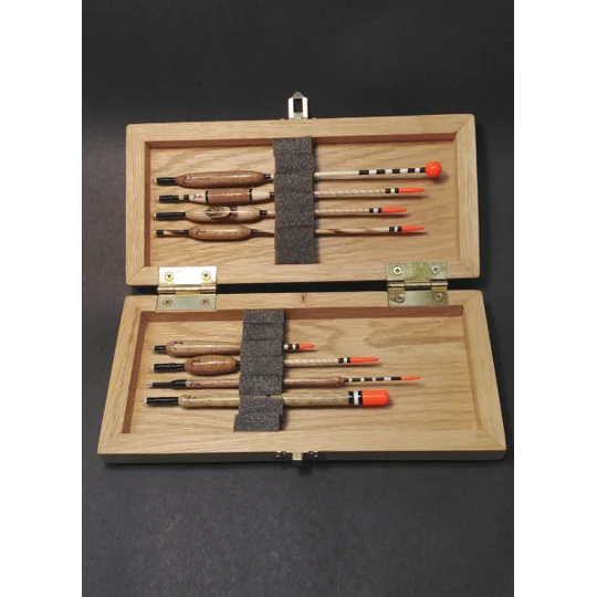 Traditional fishing floats protected in foam-lined oak float case