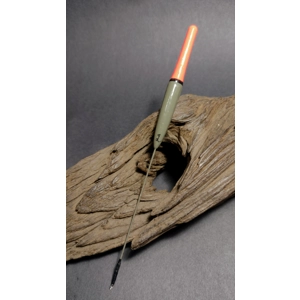 Handmade Reg Rhygini-style grayling float with balsa body and wire stem resting on driftwood.