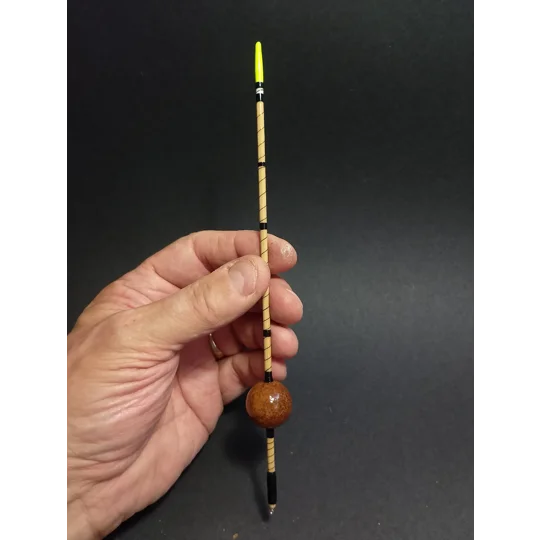 Unique handmade waggler fishing float with natural oak gall body, held in hand to show size and scale