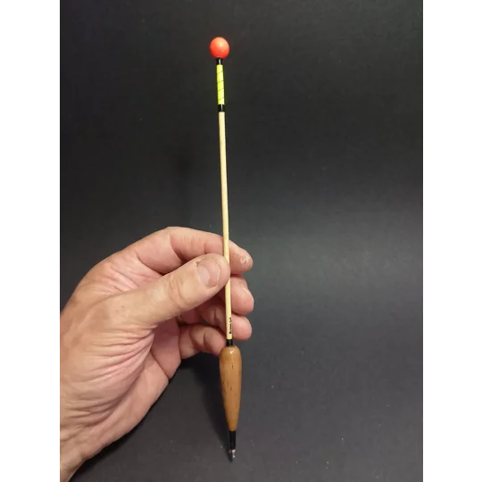 Handmade balsa-bodied Irish bream slider fishing float held in hand to show size and scale