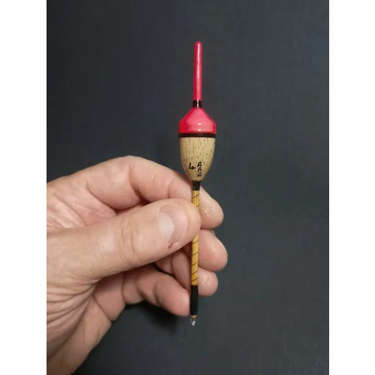 Handmade 4AAA balsa perch bob fishing float held in hand to show size and scale