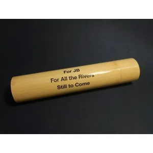 Personalised bamboo fishing float storage tube with custom printed message protected beneath a lacquered finish