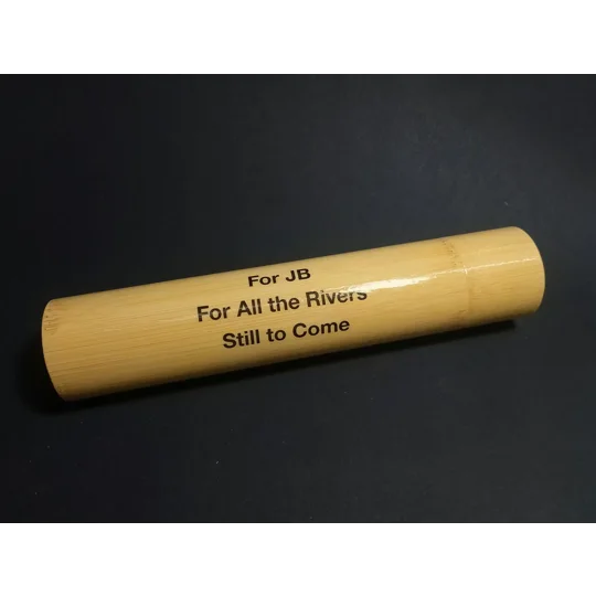 Personalised bamboo fishing float storage tube with custom printed message protected beneath a lacquered finish