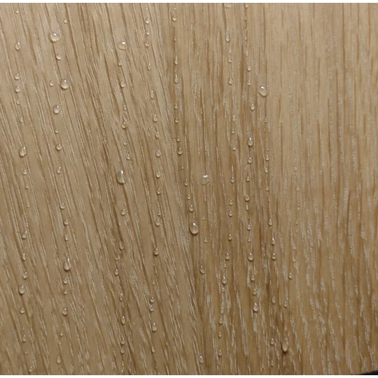 close up of water beading off the repellent surface of a traditional wooden fishing float box