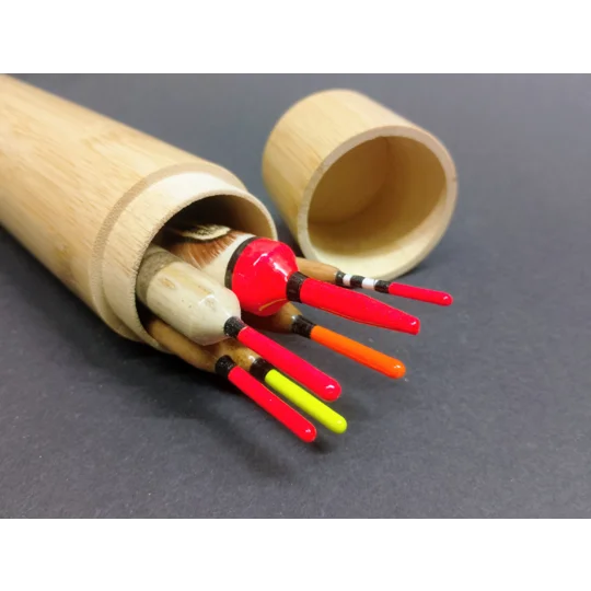 a selection of slim handmade fishing floats inside a customised bamboo float tube